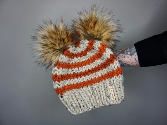 The Striped Double Pom Beanie in Oatmeal and Leaves